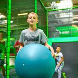 Chłopiec trzymający dużą piłkę gimnastyczną